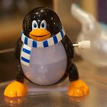 Picture of wind up Tux (Linux mascot) toy.